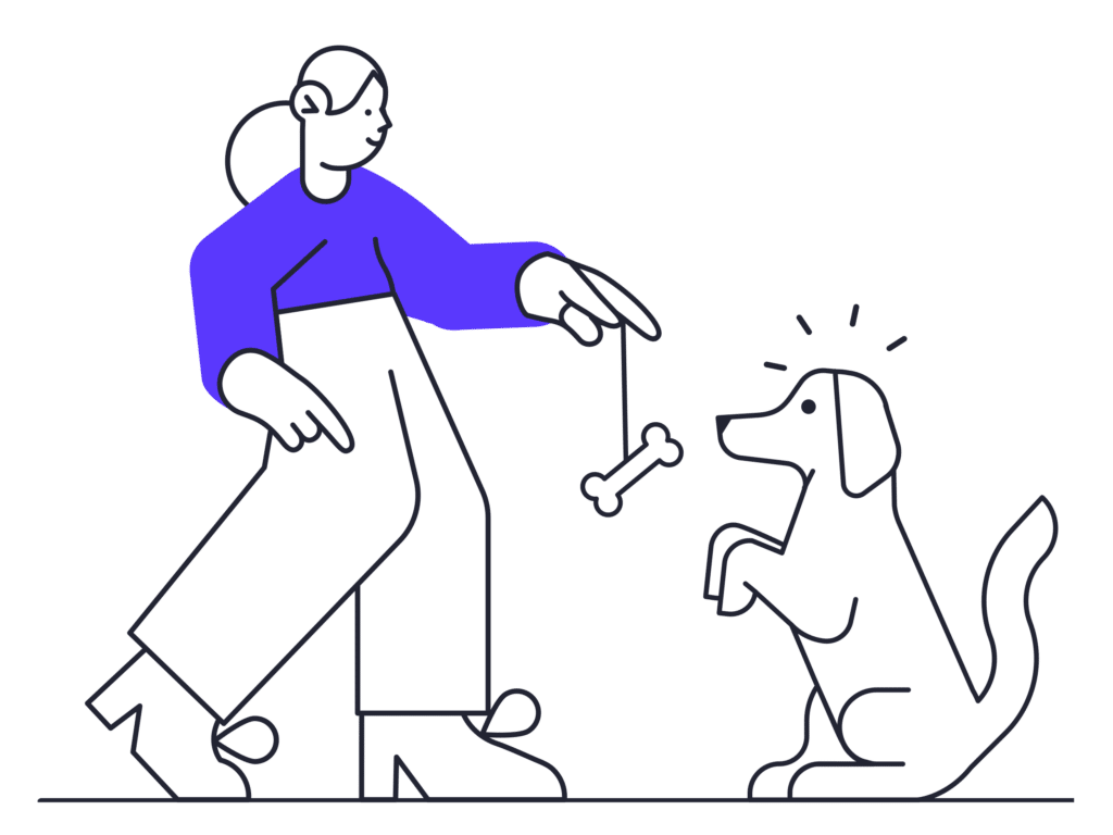 An instructor giving a dog a bone as it's training